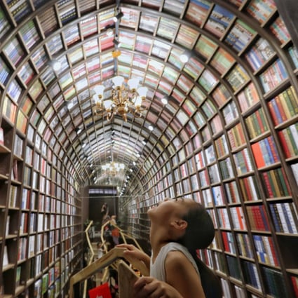 A girl looks up at the ceiling at a newly opened bookstore in Beijing on July 19, 2019. (Picture: Simon Song/SCMP)