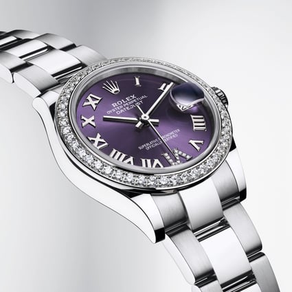 A Rolex Oyster Perpetual Datejust 31 with a bezel set with 46 brilliant-cut diamonds and an aubergine, sunray-finish dial with a diamond-set VI. 