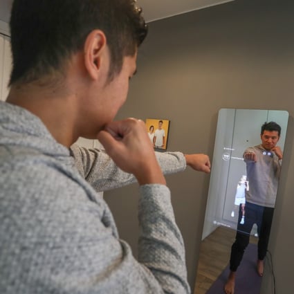 Keith Rumjahn, CEO and founder of OliveX, maker of the Kara Mirror, works out in his home. Photo: Jonathan Wong