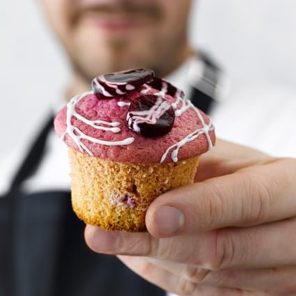 Pastry chef Christian Huembs with one of his beetroot and white chocolate muffins. Photo: Jan C. Brettschneider/DK Verlag/DPA