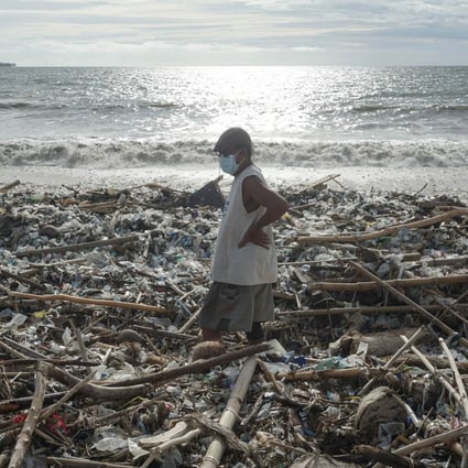 17 January 2021, Indonesia, Badung: A man stands on Kedonganan Beach coastal line among the rubbish. Photo: Dicky Bisinglasi/ZUMA Wire/dpa