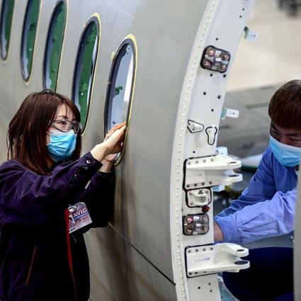 Chinese employees work on the fuselage of an aircraft at a factory in Shenyang. A Chinese women’s group are on a mission to end gender discrimination in the job marketplace. Photo: AFP