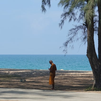 A Buddhist monk stands on a beach in Khao Lak in Thailand. Just 6.7 million travellers visited Thailand last year, down from 40 million in 2019. Photo: Getty Images