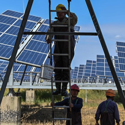 Workers at a solar power station in Jiangsu province, China, in October 2020. Photo: AFP