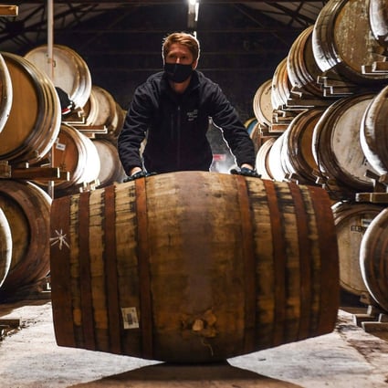 Employee Matthew Coulson rolls a whisky cask in the Glenturret Distillery’s bonded warehouse in Crieff, Scotland. It has been a tough period for Scotland’s oldest whisky maker. Photo: AFP