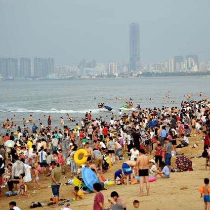 Tourists on a beach in Haikou, the capital of China’s Hainan province. Photo: Xinhua