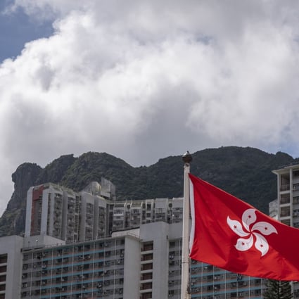 The Hong Kong and Chinese national flags are seen against the backdrop of Lion Rock mountain, symbolic of the city’s “can do” spirit. Photo: Sun Yeung