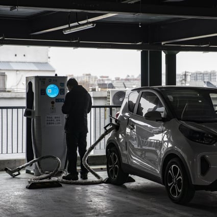 A person charges his vehicle at a Beijing Jingneng Clean Energy Co. charging station in Beijing, China, on Saturday, March 6, 2021. China, the world’s biggest car market, aims to boost auto sales and add more charging facilities for electric vehicles this year. Photographer: Qilai Shen/Bloomberg