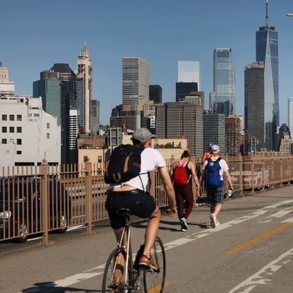 People walk and ride their bike across Brooklyn Bridge on June 22, 2020. The US has been investing a declining share of its GDP (2.3 per cent in 2017) in infrastructure. Photo: Getty Images/AFP 