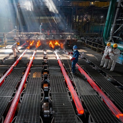 Workers make iron bars at a steel factory in Lianyungang, in eastern Jiangsu province, on February 12. Photo: AFP