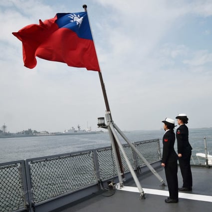 Taiwanese sailors salute the island’s flag on the deck of the Panshih supply ship after taking part in annual drills, at the Tsoying naval base in Kaohsiung, in January 2018. Photo: AFP 