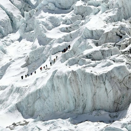 Climbers cross the Khumbu icefall of Mount Everest. The route across is prepared at the start of the climbing season by highly skilled Nepalese mountaineers. Photo: AFP/Prakash Mathema