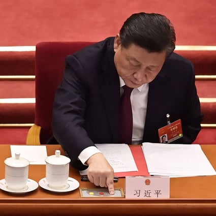 President Xi Jinping votes on changes to Hong Kong’s election system during the closing session of the National People’s Congress at the Great Hall of the People in Beijing on March 11. Photo: AFP