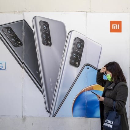 A pedestrian walks past advertisements at a Xiaomi Corp store in Hong Kong on December 2, 2020. Photo: Bloomberg