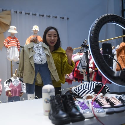 A live-streamer sells children’s clothes in Zhili town, Huzhou, Zhejiang province, on February 8. Live-streaming, group buying and new forms of social shopping are emerging in Asia as e-commerce explodes. Photo: Xinhua