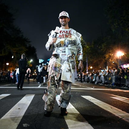 A man dresses up as “Fake News Media” in the annual Village Halloween parade on Sixth Avenue, New York, on October 31, 2019. Photo: AFP