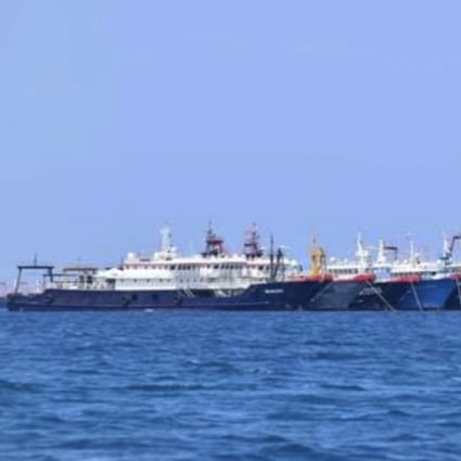 In this Sunday, March 7, 2021, photo provided Sunday, March 21, 2021, by the Philippine Coast Guard/National Task Force-West Philippine Sea, some of the 220 Chinese vessels are seen moored at Whitsun Reef, South China Sea. The Philippine government expressed concern after spotting more than 200 Chinese fishing vessels it believed were crewed by militias at a reef claimed by both countries in the South China Sea, but it did not immediately lodge a protest. (Philippine Coast Guard/National Task Force-West Philippine Sea via AP)