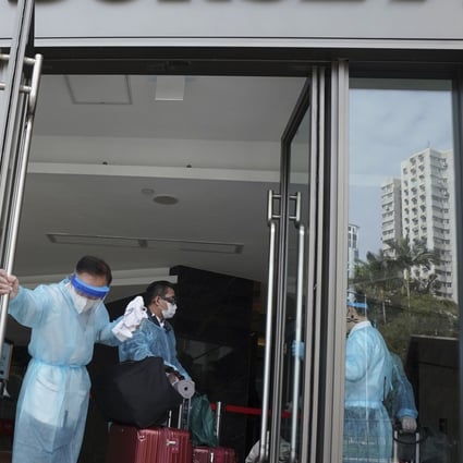 A traveller enters a designated Hong Kong hotel to undergo quarantine on December 18. The required period of isolation was increased from 14 to 21 days on December 25. Photo: Felix Wong