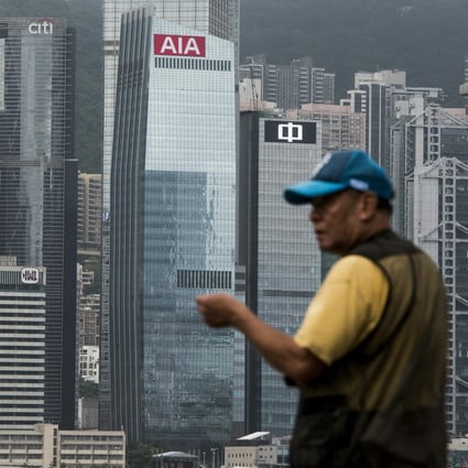 A man fishes in front of the AIA Central building in Hong Kong. Photo: Bloomberg