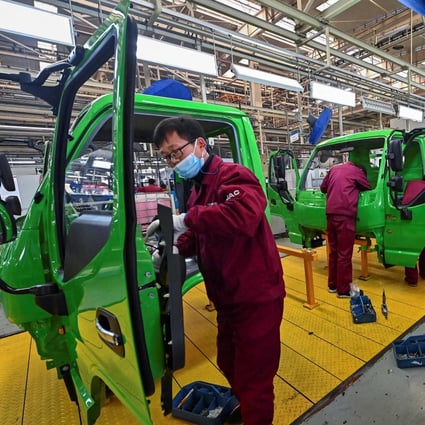Employees work on a truck assembly line at a factory for Jianghuai Automobile Group in Qingzhou, Shandong province, in eastern China. Photo: AFP