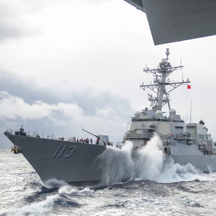 The Arleigh Burke-class guided-missile destroyer USS John Finn approaches the aircraft carrier USS Theodore Roosevelt for a replenishment-at-sea on Jan 14, 2021 in the Indo-Pacific area. Photo: Handout