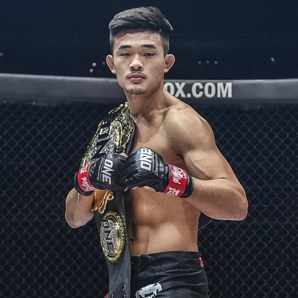 Christian Lee poses his ONE Championship lightweight title.