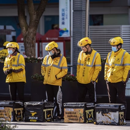 Food delivery couriers for Meituan Dianping stand with insulated bags during a morning briefing on a street in Shanghai, on November 29, 2020. Photo: Bloomberg