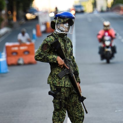 A Philippine policeman stands guard during last year’s lockdown in Metro Manila. Photo: AFP