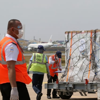 Workers transport a package of Sinovac Covid-19 vaccine at Phnom Penh airport on March 26. Photo: Xinhua