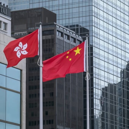 The Chinese national flag (right) and Hong Kong’s. Photo: Bloomberg
