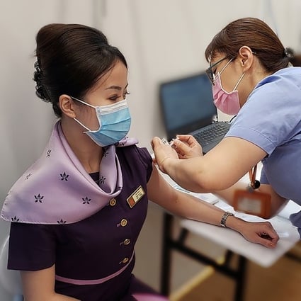 A Hong Kong Airlines employee receives their first dose of a Covid-19 vaccine. Photo: Handout