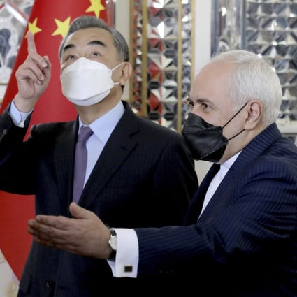Iranian Foreign Minister Mohammad Javad Zarif welcomes Chinese Foreign Minister Wang Yi in Tehran on Saturday. Photo: AP