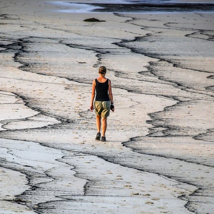 Ash from wildfires forms patterns at Narrawallee Beach in New South Wales, Australia, in January 2020. Photo: Bloomberg