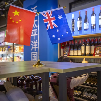 A visitor looks at a display of Australian wines at the China International Import Expo in Shanghai on November 5. Disputes over issues ranging from Xinjaing to 5G and Australia’s support for a probe into the origin of the coronavirus have sparked a trade spat and higher Chinese  import duties or outright bans on Australian products, including wine and coal. Photo: AP