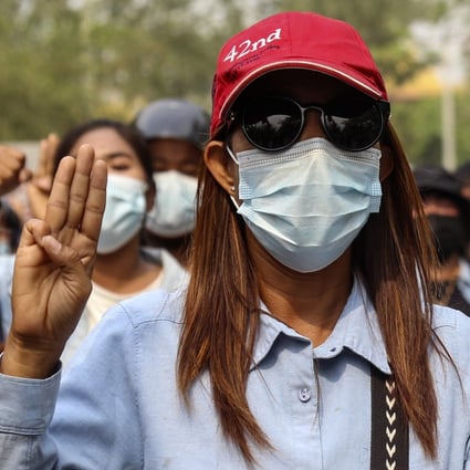 A protester flashes a three-finger salute during a march to condemn the military coup in Mandalay. Photo: EPA-EFE