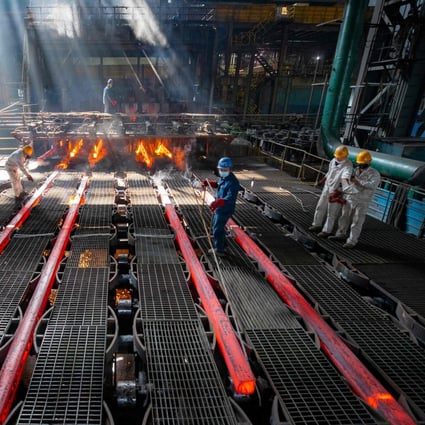 Workers make iron bars in a steel factory in Lianyungang, in China’s eastern Jiangsu province. Photo: AFP