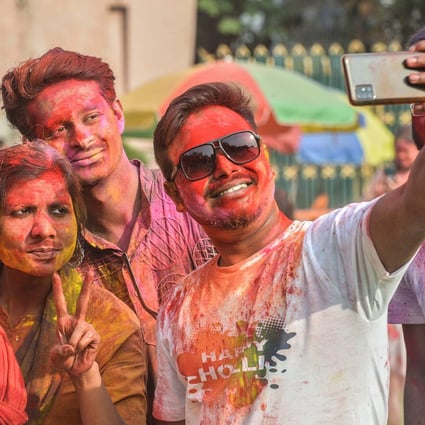 Revellers take selfies as they celebrate Holi, the spring festival of colours, in Siliguri. Photo: AFP