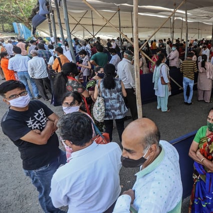 Indians wait in queue to receive Covid-19 inoculation at a vaccination centre in Mumbai city on April 5. The state government of Maharashtra announced new restrictions, including a night curfew and a strict lockdown on the weekends to combat a spike in coronavirus cases. Photo: EPA-EFE 