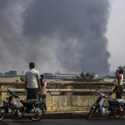 Smoke billows from the industrial zone of Hlaing Thar Yar, in Yangon, Myanmar, home to Chinese-run factories. Photo: AP