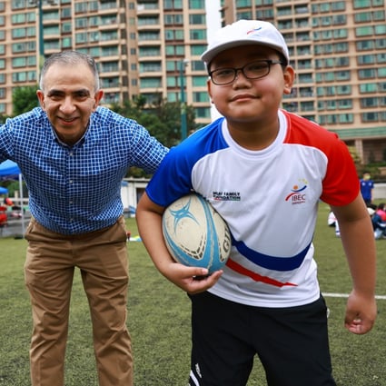Integrated Brilliant Education Limited students Aris Gurung, school CEO and cofounder Manoj Dhar and student Abhi Limbu at a Hong Kong Rugby Union rugby fun day at King’s Park, Jordan in April. Photo: SCMP / May Tse  