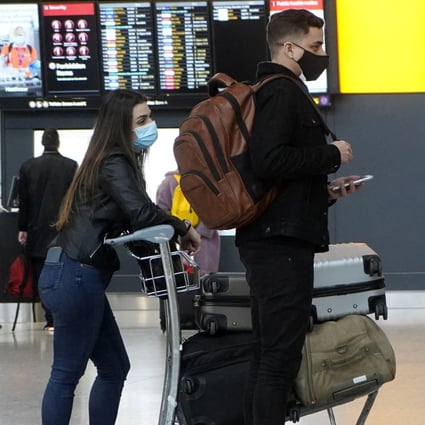 Travellers wait near the check-in desks at Terminal 2 of Heathrow Airport. Photo: AFP
