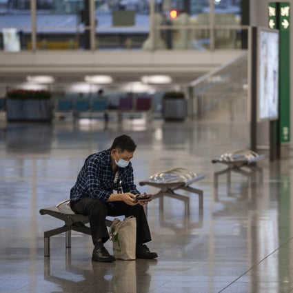 A passenger wearing a face mask waits at Hong Kong International Airport on October 24, 2020. Photo: CWH 