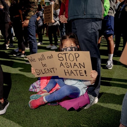 A child holds a sign during an Asian-Americans and Pacific Islanders Rally Against Hate in New York on March 21. Photo: Bloomberg
