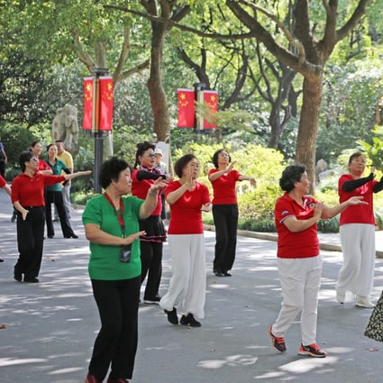 Elderly people dance in a park in Shanghai, China. Photo: Getty