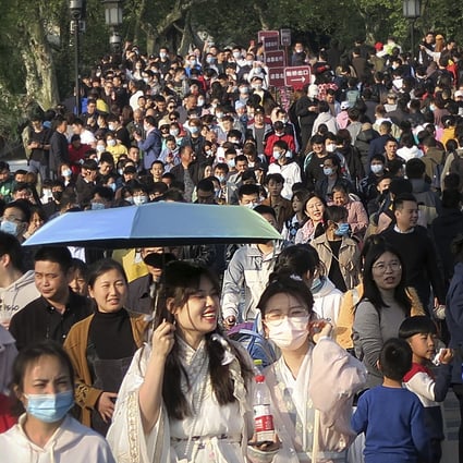 Visitors walk across a causeway at the West Lake in Hangzhou in eastern China’s Zhejiang province on April 4. Domestic tourists were out in force at some of China’s most popular tourist sites on a holiday weekend as the country continues to report few new cases of coronavirus within its borders. Photo: AP
