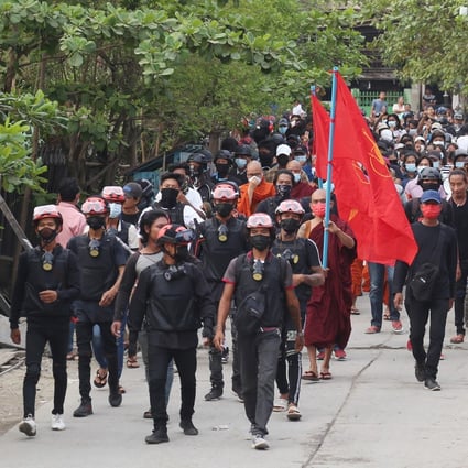 Demonstrators march during a protest in Mandalay. Business activity in Myanmar has plummeted since the coup. Photo: EPA-EFE