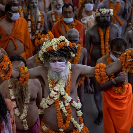 Naga Sadhus, or Hindu holy men, participate in the procession for taking a dip in the River Ganges during the Kumbh Mela festival, to which crowds are flocking despite India’s surge in Covid-19 cases. Photo: Reuters