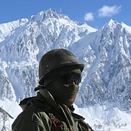 An Indian army soldier stands on a snow covered road in the Himalayas. Photo: AFP