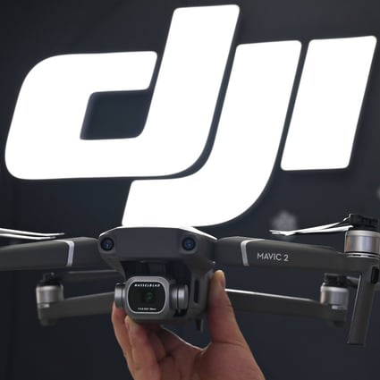 An employee shows the new Mavic Pro 2 drone in a DJI store in Shanghai on May 22, 2019. Photo: AFP