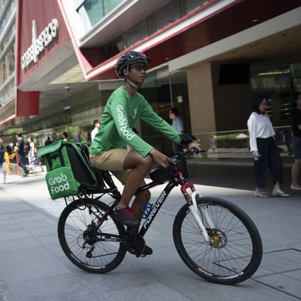 A rider for GrabFood, Grab Holdings online food-delivery platform, cycles outside Raffles Place in Singapore. The company plans to go public via a US-listed special purpose acquisiton company. Photo: Bloomberg